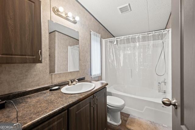 full bath featuring visible vents, toilet, shower / bathtub combination with curtain, a textured ceiling, and vanity