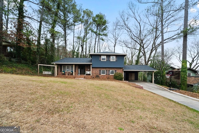 view of front of property with a front yard, a carport, and a porch