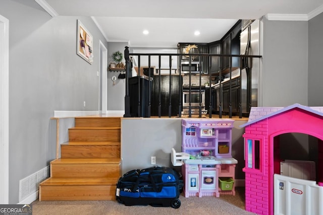 stairway featuring ornamental molding and carpet floors