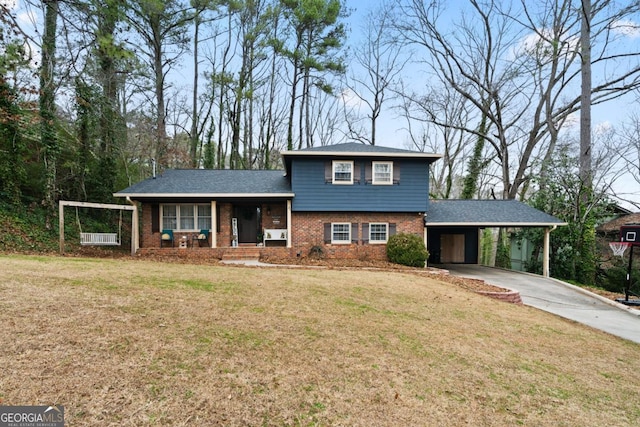 split level home with a carport, covered porch, and a front yard