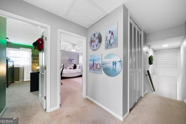 corridor featuring light colored carpet