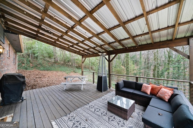 wooden terrace featuring area for grilling and outdoor lounge area
