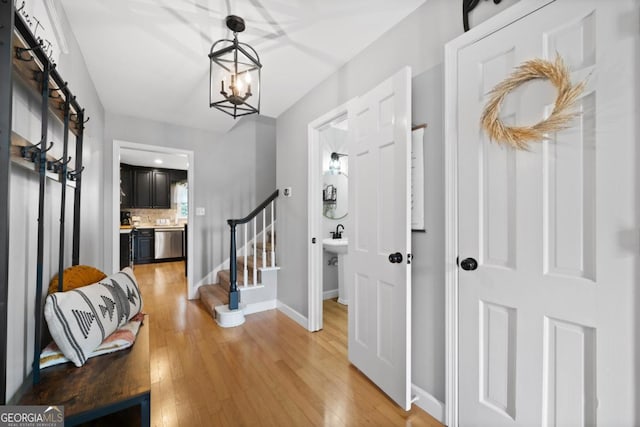 entrance foyer with hardwood / wood-style flooring and a chandelier