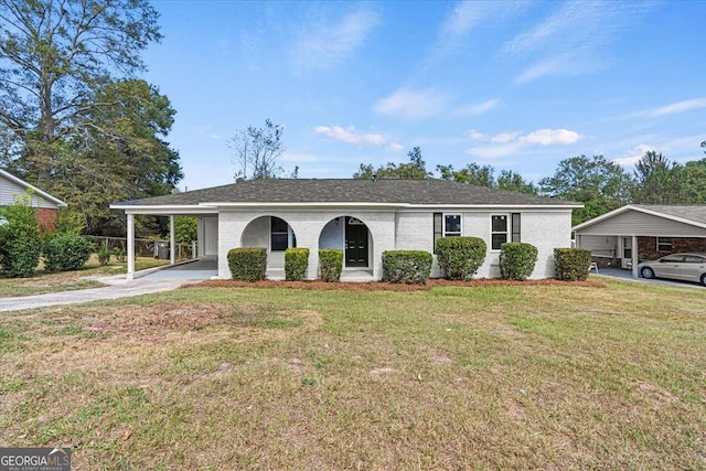 view of front facade with a front yard and a carport