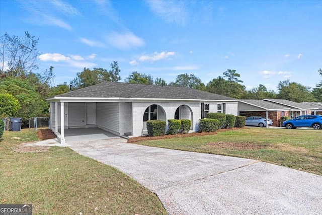 ranch-style home featuring a front yard and a carport