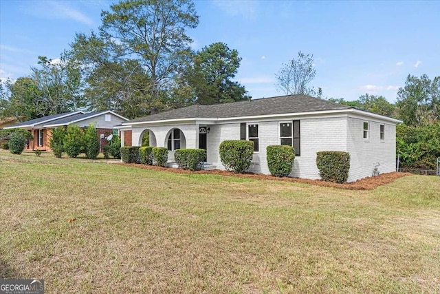 ranch-style home with a front lawn