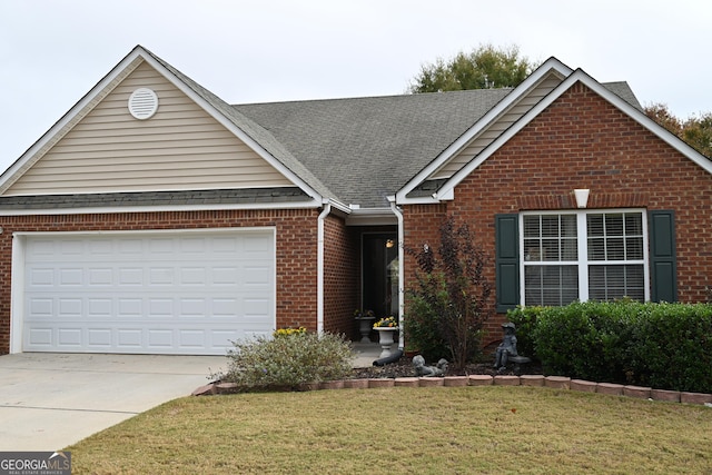 view of front of house with driveway, a front lawn, roof with shingles, a garage, and brick siding