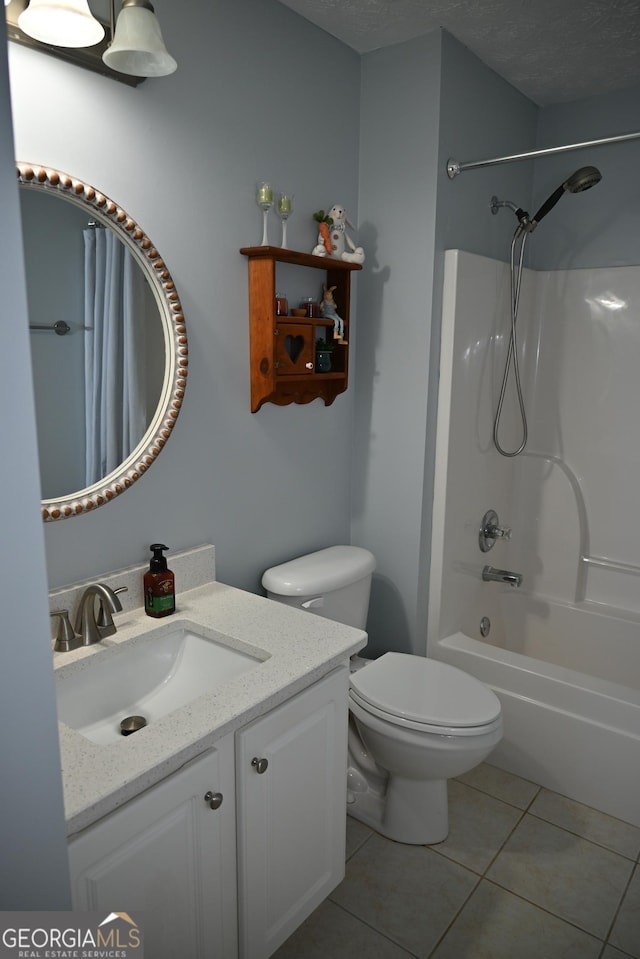 full bathroom featuring tile patterned flooring, vanity, shower / tub combo with curtain, toilet, and a textured ceiling