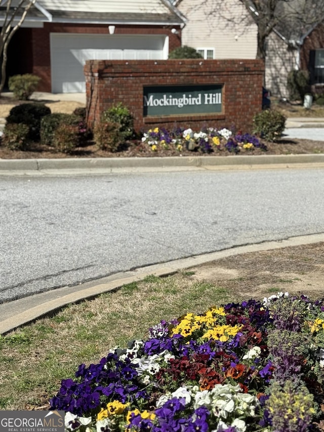 community / neighborhood sign with an attached garage