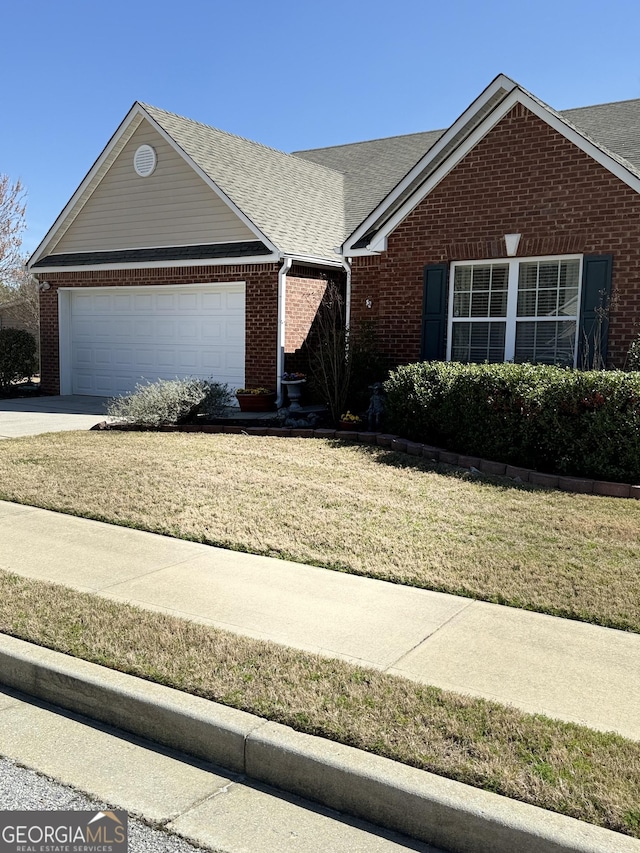 single story home with brick siding, a front yard, a garage, and roof with shingles