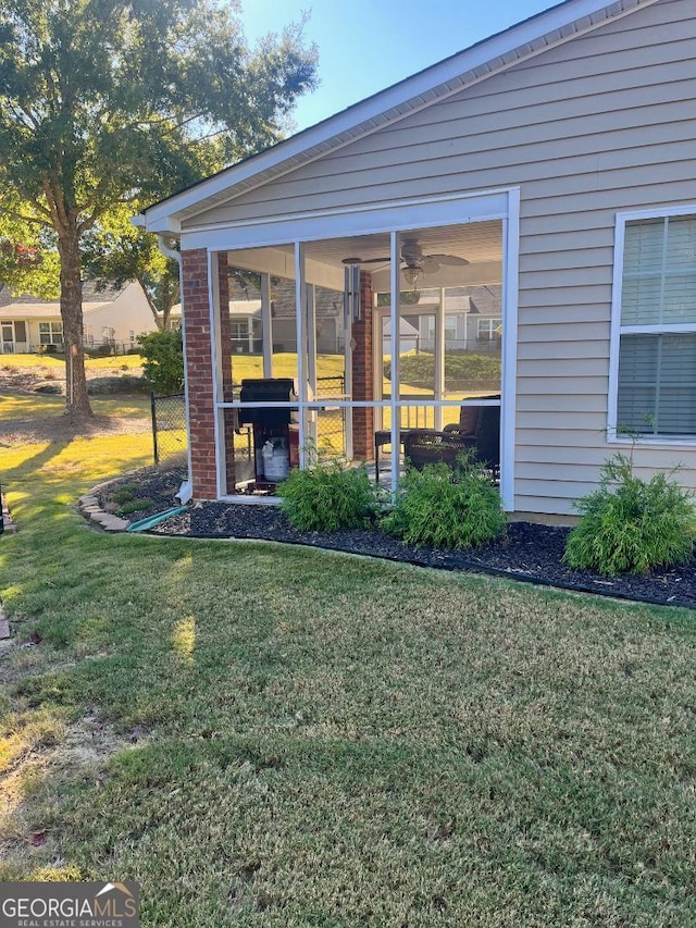 exterior space with a sunroom and a yard