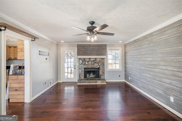 unfurnished living room with a fireplace, ornamental molding, dark hardwood / wood-style floors, and a textured ceiling