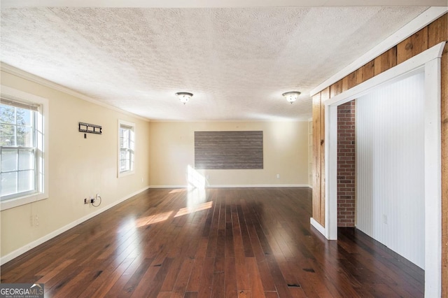 unfurnished room with dark wood-type flooring and a textured ceiling