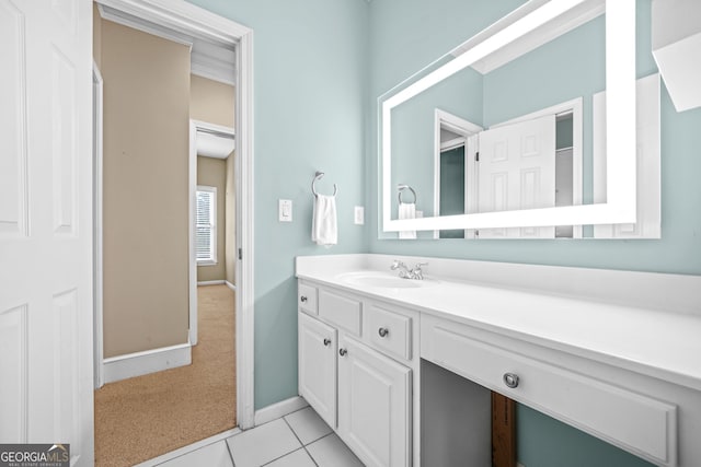 bathroom featuring vanity, baseboards, and tile patterned floors