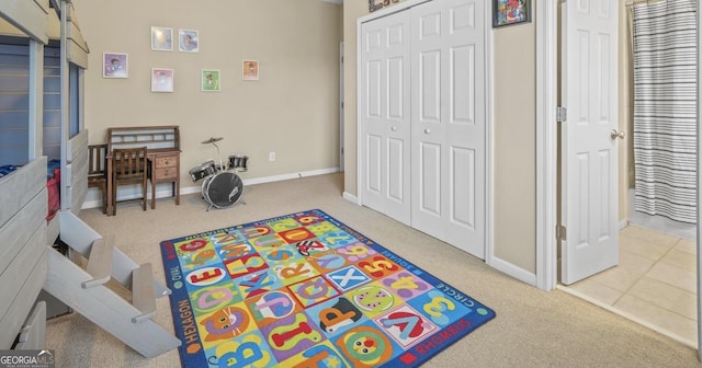 rec room featuring carpet floors and baseboards