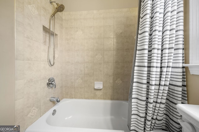 bathroom with shower / bath combo and toilet