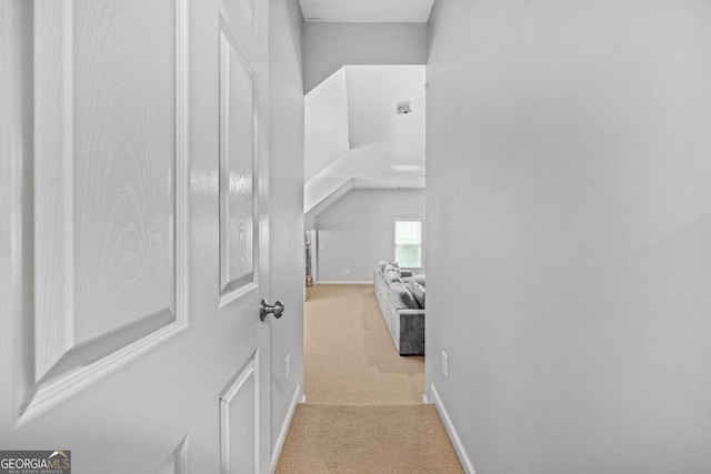 hall with carpet floors and baseboards