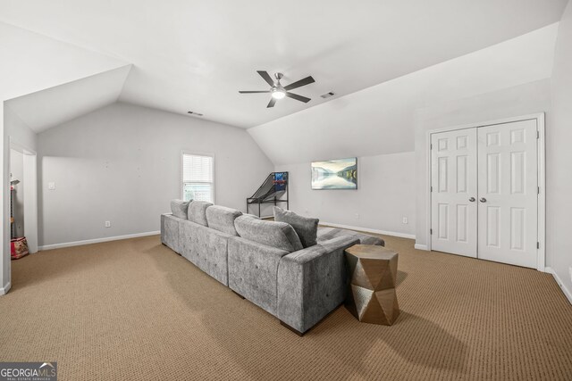 carpeted living room with visible vents, vaulted ceiling, baseboards, and ceiling fan