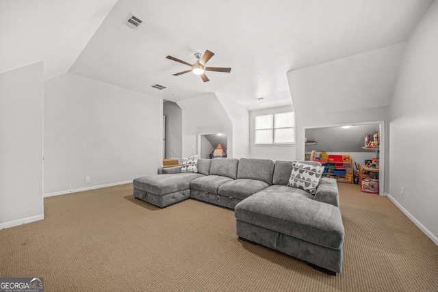 carpeted living area with a ceiling fan, visible vents, vaulted ceiling, and baseboards