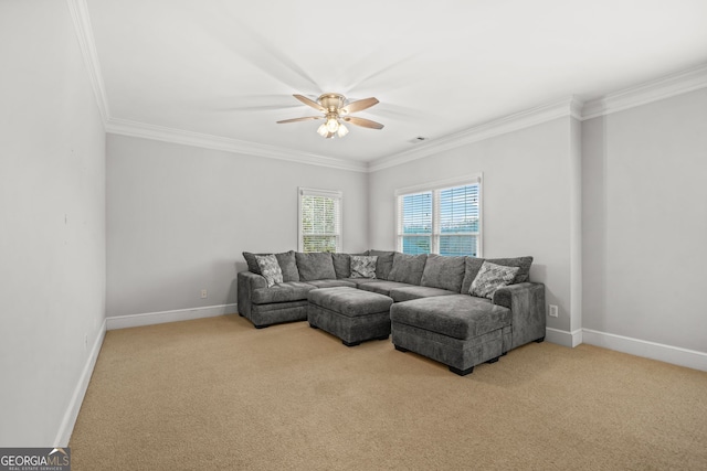 living area featuring carpet floors, ornamental molding, baseboards, and a ceiling fan