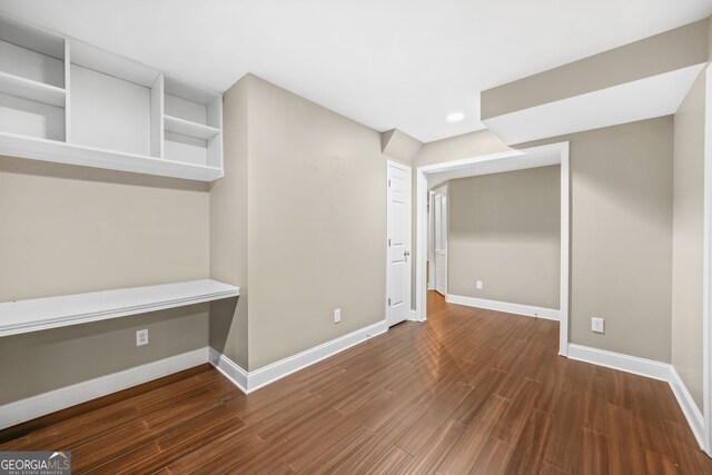 interior space featuring baseboards and wood finished floors