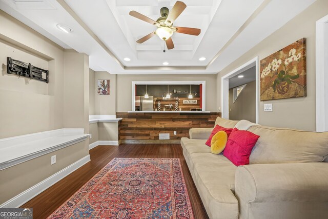 living room featuring recessed lighting, a ceiling fan, baseboards, dark wood-style floors, and a tray ceiling