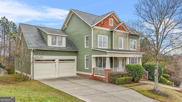 craftsman house featuring a garage, a shingled roof, a porch, and concrete driveway