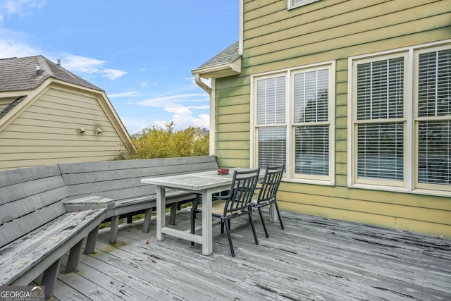 wooden terrace with outdoor dining area