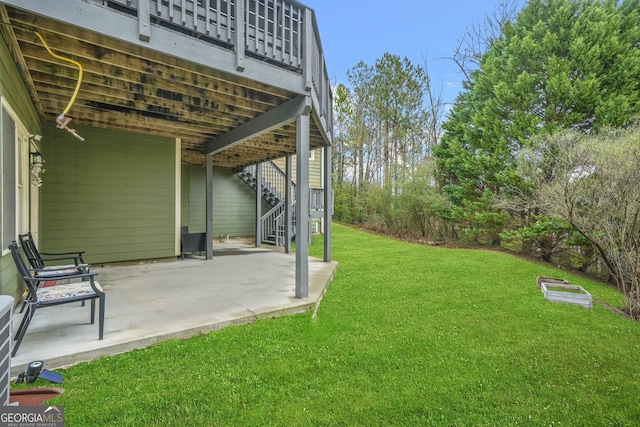 view of yard with a patio and stairway