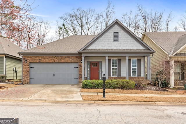 view of front facade with a garage, a shingled roof, and concrete driveway