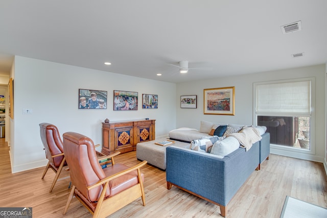 living room featuring ceiling fan and light hardwood / wood-style flooring