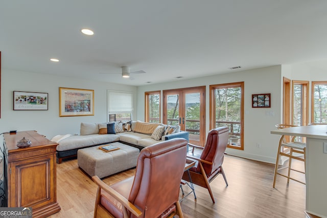 living room with french doors, ceiling fan, and light hardwood / wood-style flooring