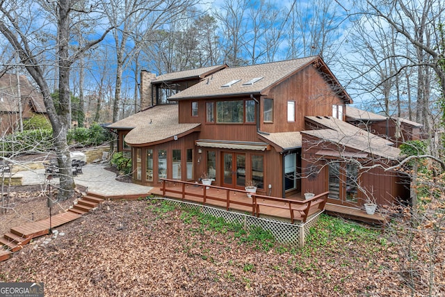 back of house featuring a deck and french doors