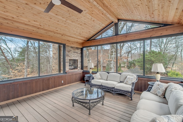 sunroom / solarium with ceiling fan, wooden ceiling, a healthy amount of sunlight, and vaulted ceiling with beams