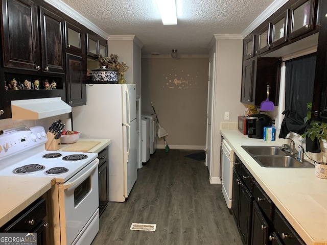 kitchen with white appliances, glass insert cabinets, light countertops, under cabinet range hood, and a sink