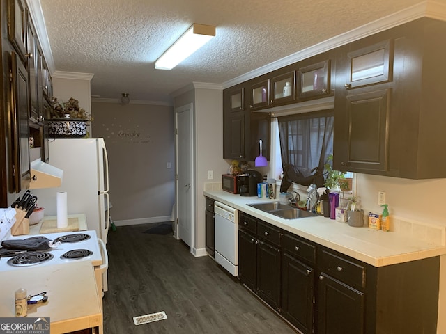 kitchen featuring dark wood-style floors, crown molding, light countertops, a sink, and white appliances