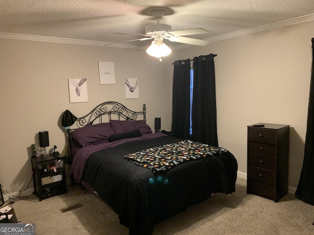 bedroom with visible vents, ornamental molding, a textured ceiling, and light colored carpet