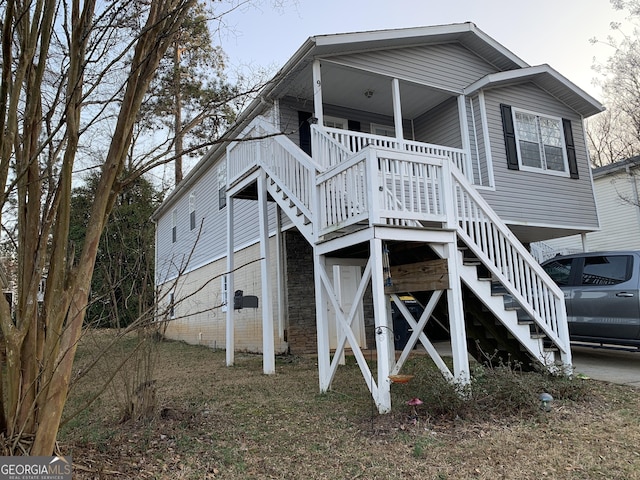 view of front of home with covered porch and stairway