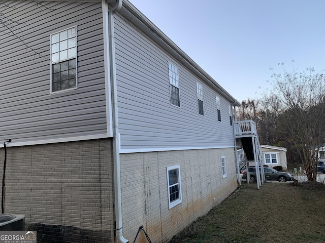 view of side of home featuring brick siding