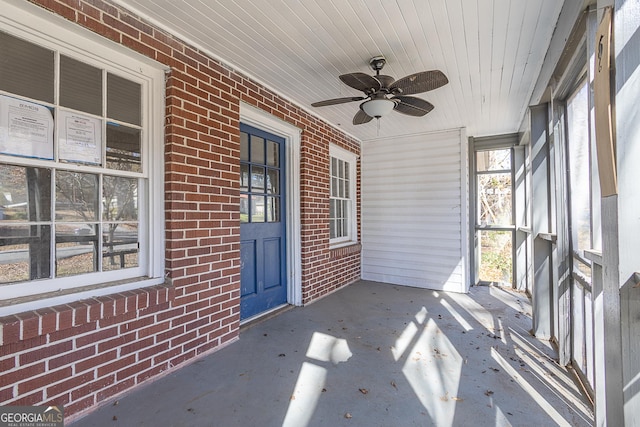 unfurnished sunroom featuring ceiling fan