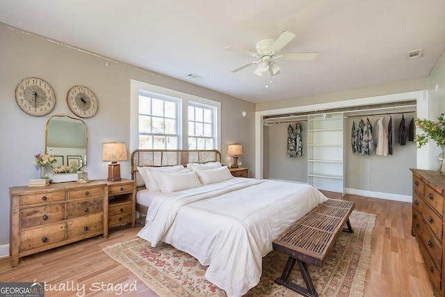 bedroom with ceiling fan, light wood-type flooring, and a closet