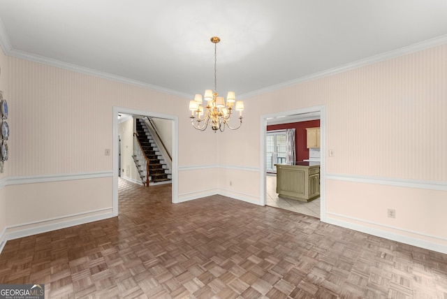 unfurnished dining area featuring an inviting chandelier, light parquet flooring, and crown molding