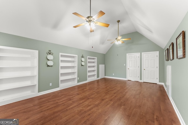 unfurnished living room with wood-type flooring, built in features, and vaulted ceiling