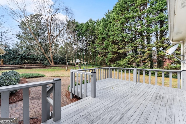 wooden terrace featuring a playground