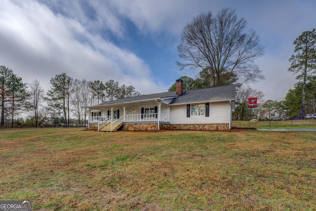 ranch-style home with covered porch and a front lawn