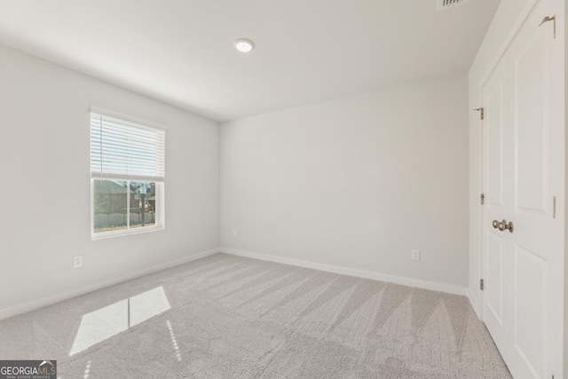 unfurnished bedroom with carpet, visible vents, and baseboards