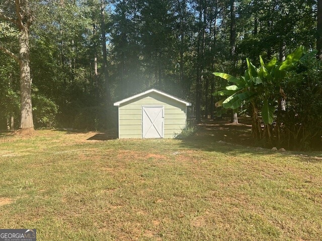 view of outdoor structure with a lawn