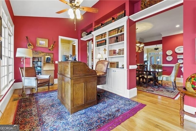 dining room featuring baseboards, wood finished floors, an inviting chandelier, and crown molding