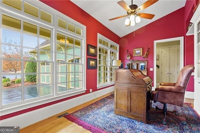 office space featuring baseboards, wood finished floors, a ceiling fan, and ornamental molding