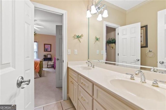 bathroom with tile patterned flooring, crown molding, double vanity, and a sink